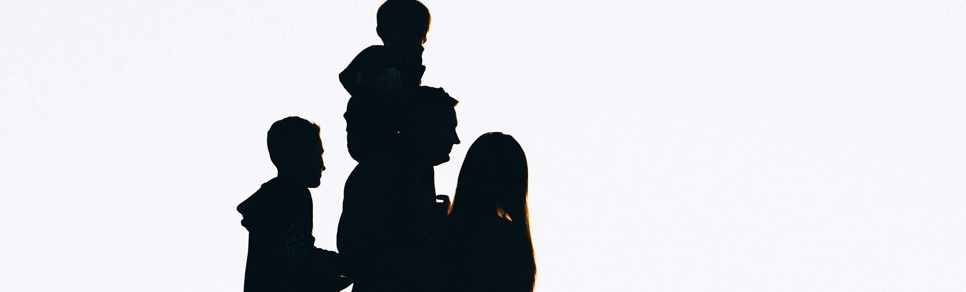 silhouette of a family in the sunset 