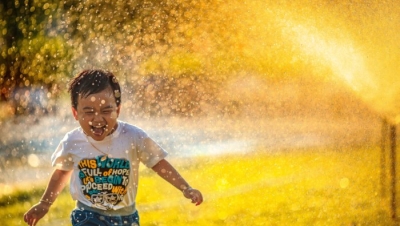 Kid Running through Sprinkler