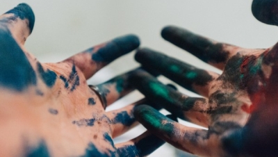 A child's paint-covered hands