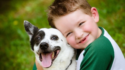 little boy hugging his dog