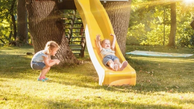 Child sliding on a backyard slide