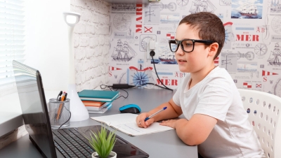 boy doing homework on laptop