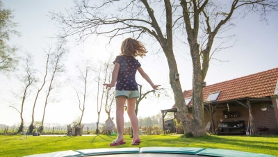Girl exercising by jumping on a trampoline