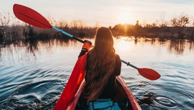 Woman paddling in lake