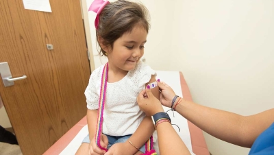 girl at doctors office getting first aid