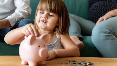 family saving money in a piggy bank