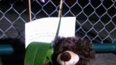 A teddy bear sits outside the chained-link fence at Fisher’s Landing Elementary School in Vancouver, Oct. 3, 2014. (KOIN 6) 