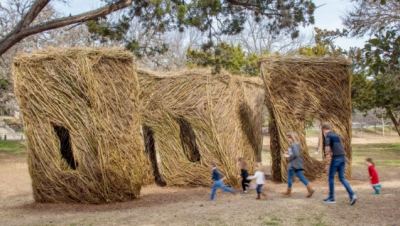 Kids running through Stickwork structure in Pease Park