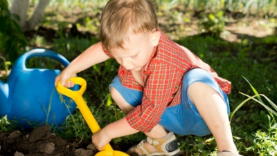 Toddler digging in the dirt.