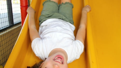 Girl playing on a slide.