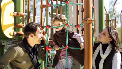 Parents playing with child on playground